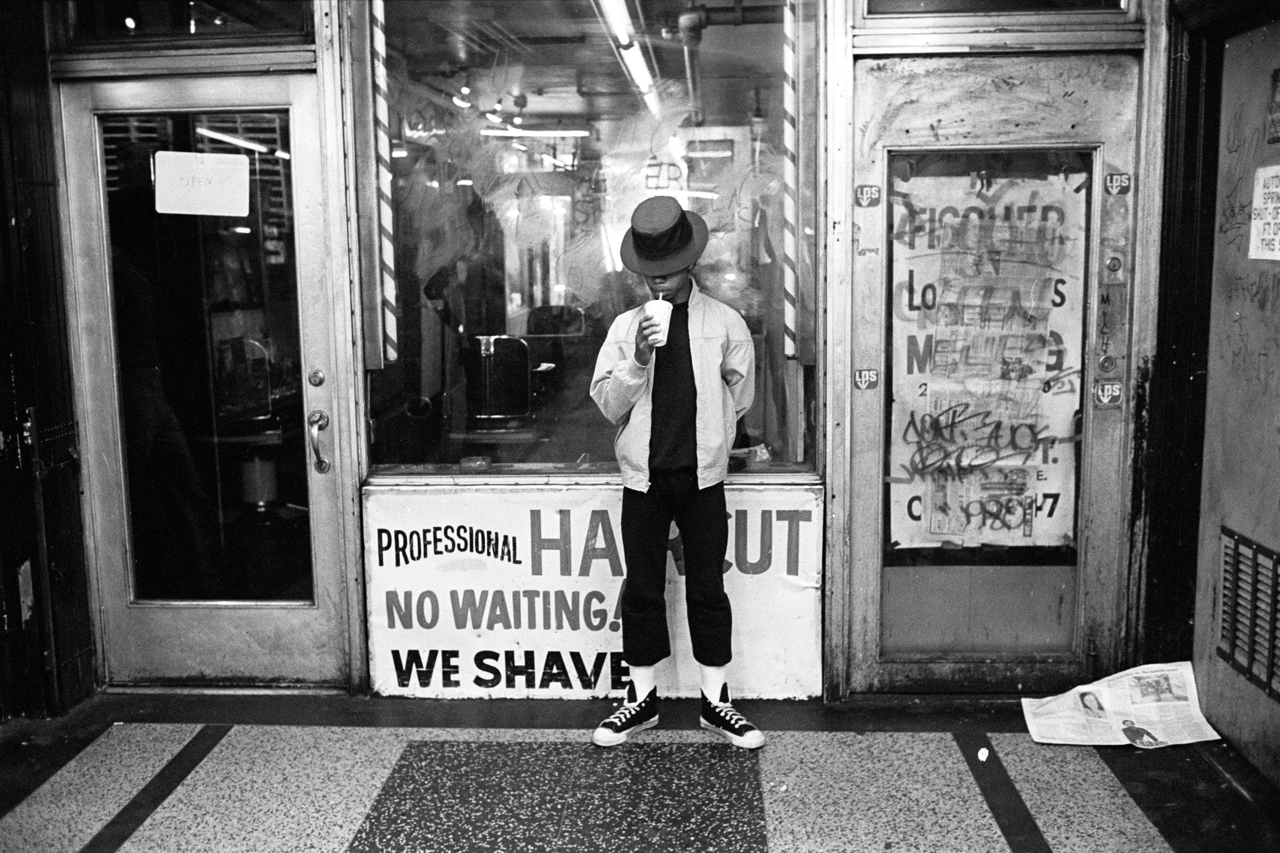 1980 - New York, New York, USA: Teenage hustler drinks a soda in the 8th Avenue subway station entrance in Times Square. (Stephen Shames/Polaris)